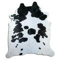 Peau de vache noir et blanc d’environ 240 × 210 cm, vue de dessus : exactement la peau que vous recevez