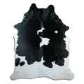 Peau de vache noir et blanc d’environ 230 × 190 cm, vue de dessus : exactement la peau que vous recevez